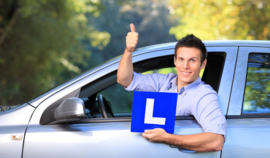Happy male holding a L sign and giving thumb up